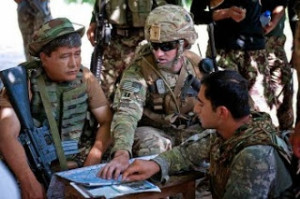 A U.S. Army captain, center, speaks with an Afghan army officer, left, during a patrol break June 15 in Afghanistan’s Najgarhar province. (Sgt. Margaret Taylor/U.S. Army)