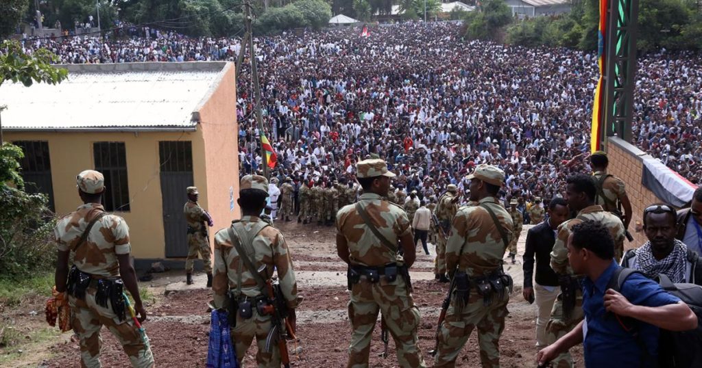 Armed security officials watch as protesters stage a protest against the regime in Bishoftu, Ethiopia on October 02, 2016. © 2016 Getty Images